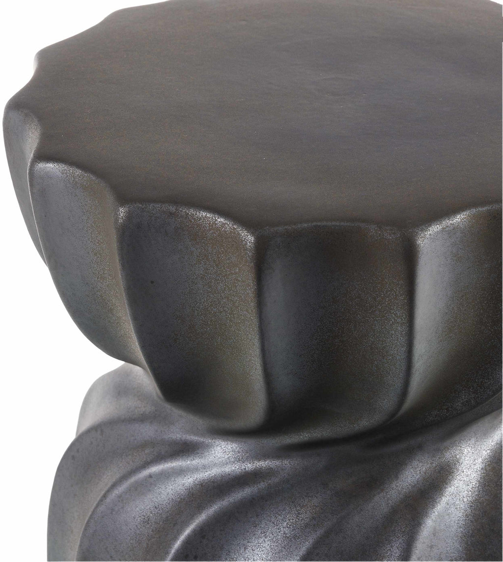 Close-up of a textured black Minimalist Modern Ceramic Stool Contemporary design sophisticated Scandinavian style on a white background