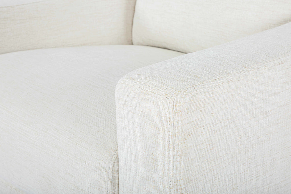 Close-up of a white sofa with visible texture, Contemporary Scandinavian-style chair, sleek minimalist seating, armchair in a room, beige accent chair with a pillow