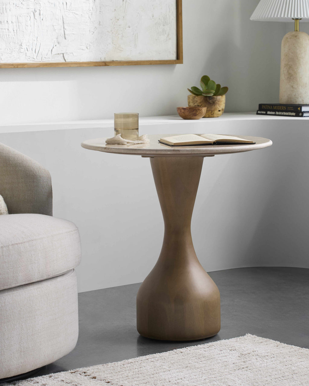 Contemporary minimalist side table with natural mango wood base and marble top modern end table in a living room