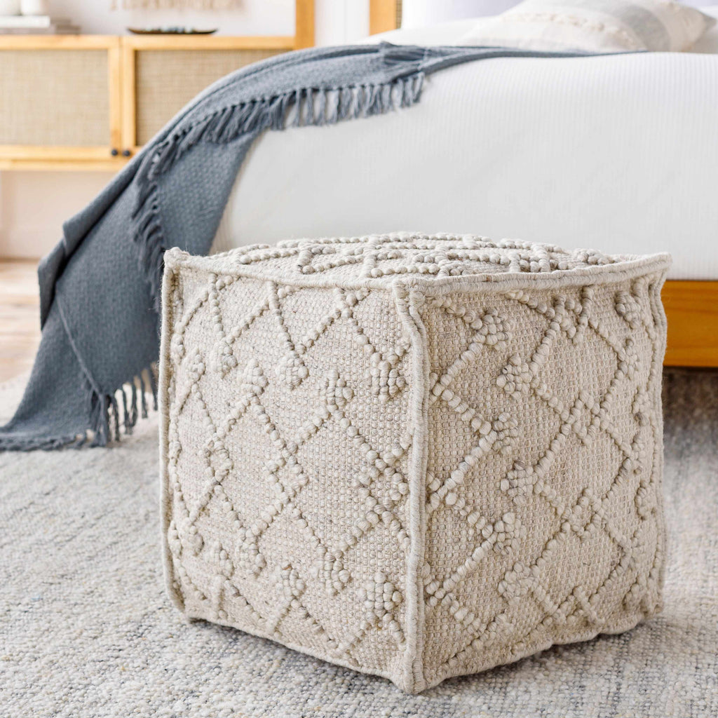 Hand Woven Wool Pouf cube-shaped in a modern bedroom