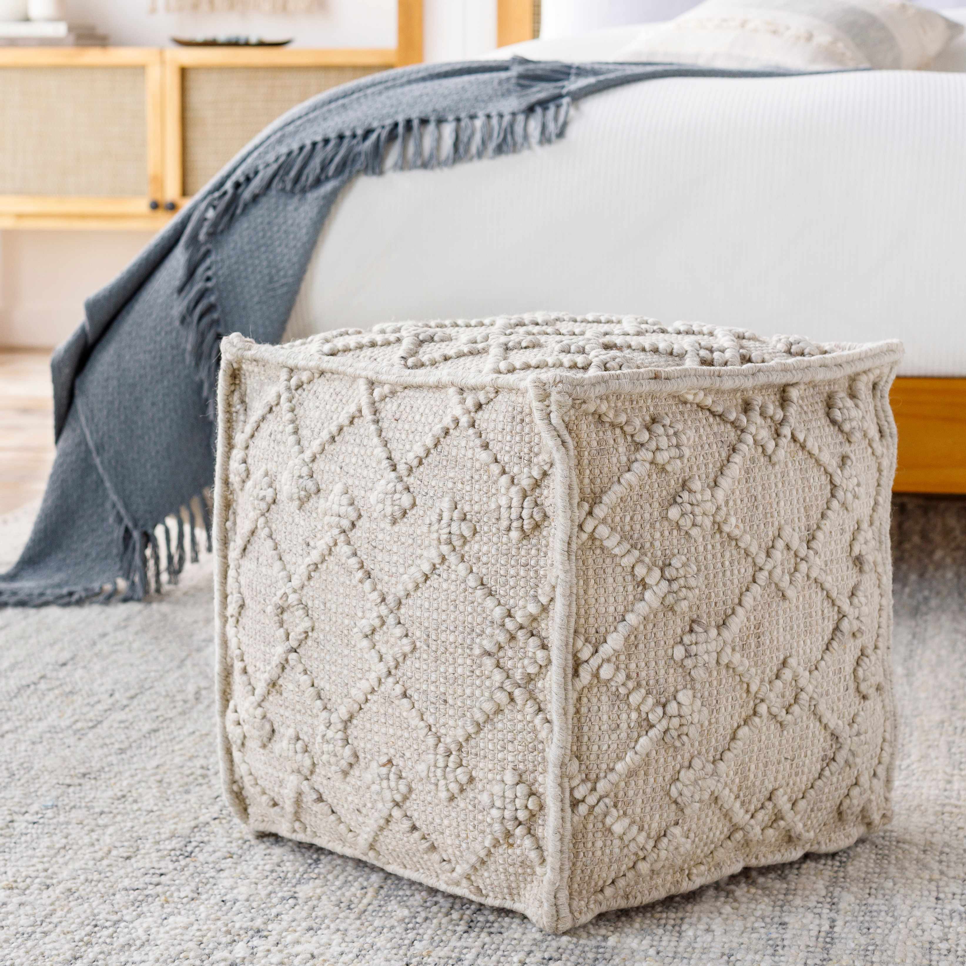 Hand Woven Wool Pouf cube-shaped in a modern bedroom