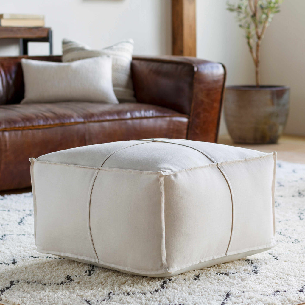 Ivory woven pouf made of linen and cotton with rectangular shape in a modern living room