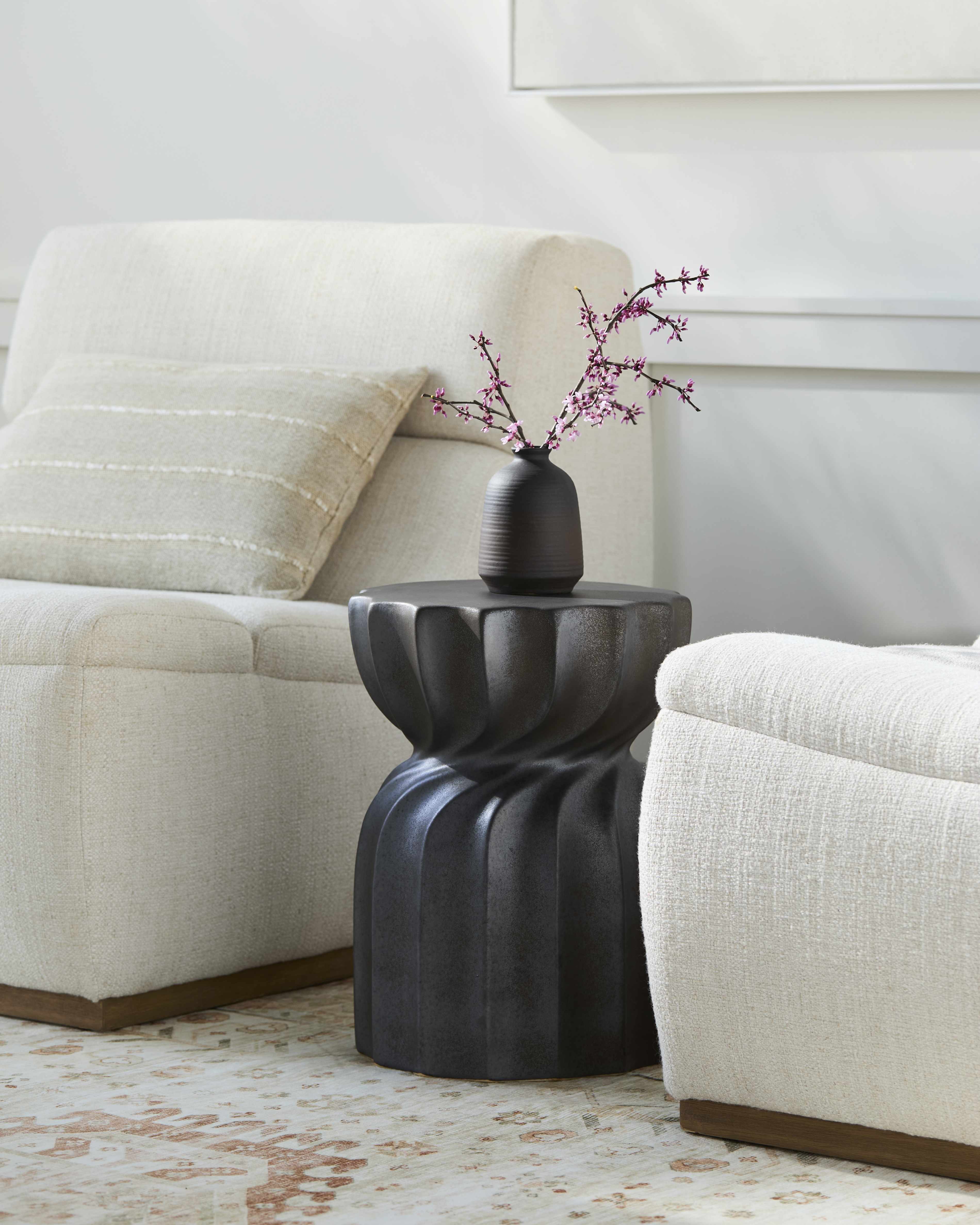 Minimalist Modern Black Ceramic Stool Contemporary design sophisticated Scandinavian style in a contemporary living room with beige sofa and black ornament with pink flower