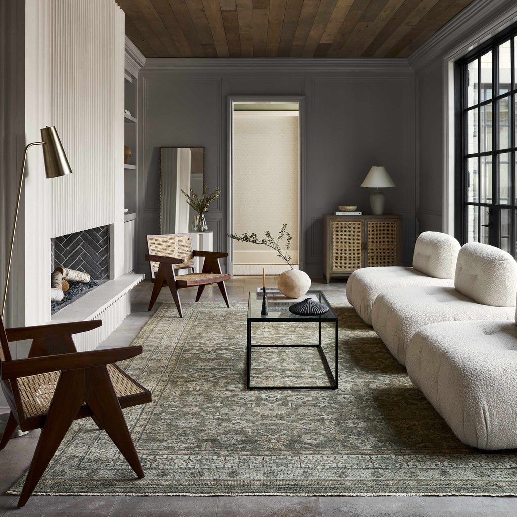 Modern living room with gray walls, wooden floor, and a gray sofa.