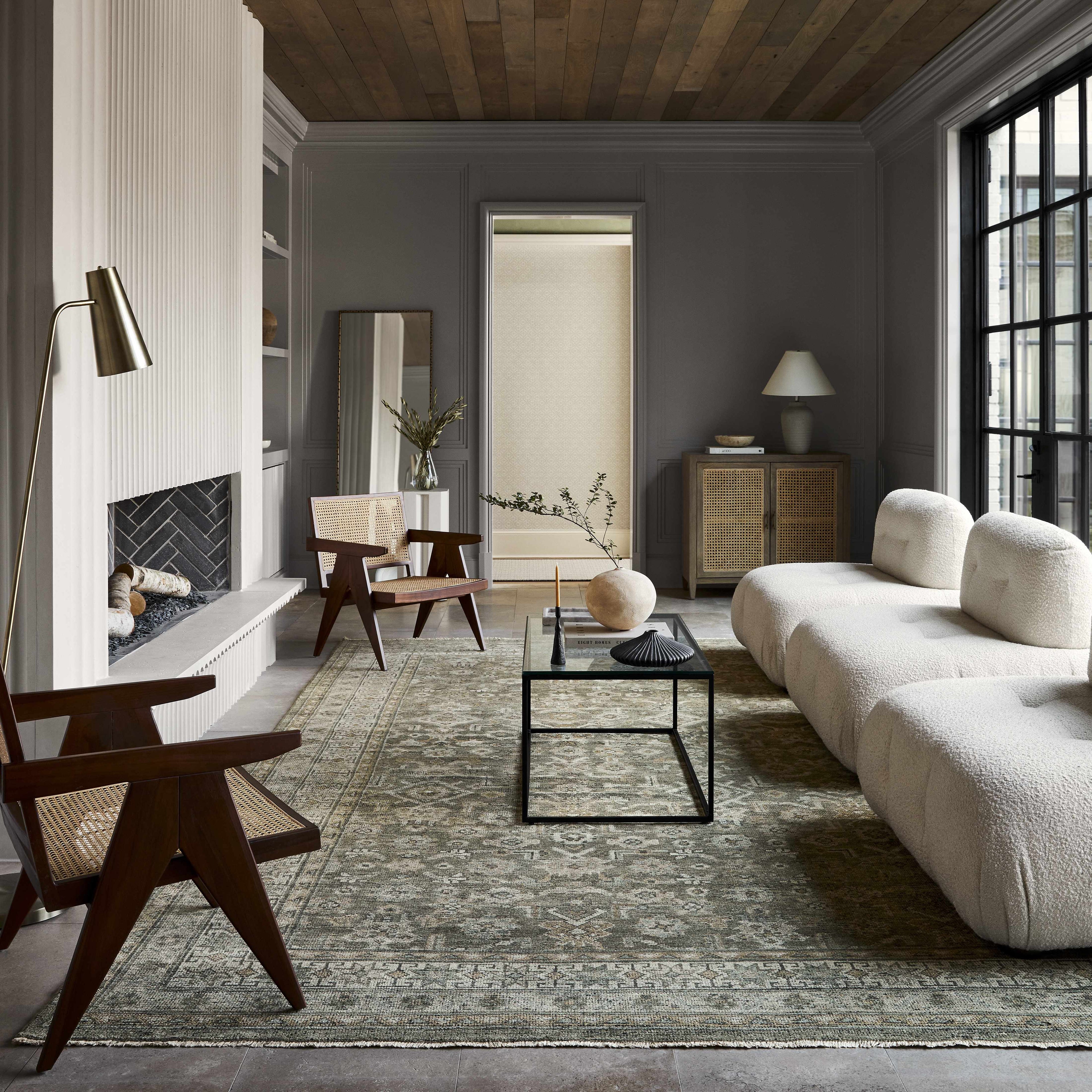 Modern living room with gray walls, wooden floor, and a gray sofa.