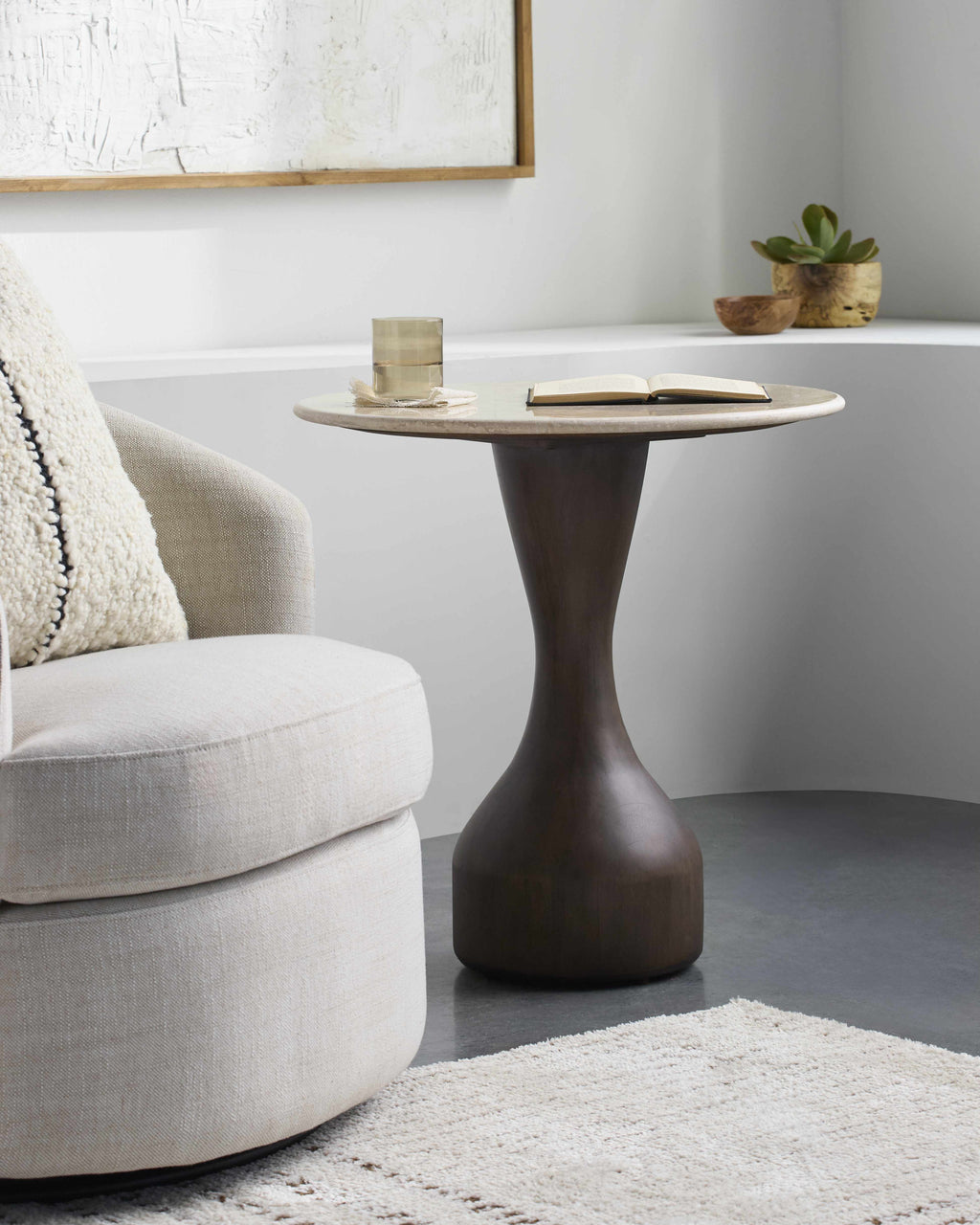 Contemporary minimalist side table with natural mango wood base and marble top modern end table in a living room