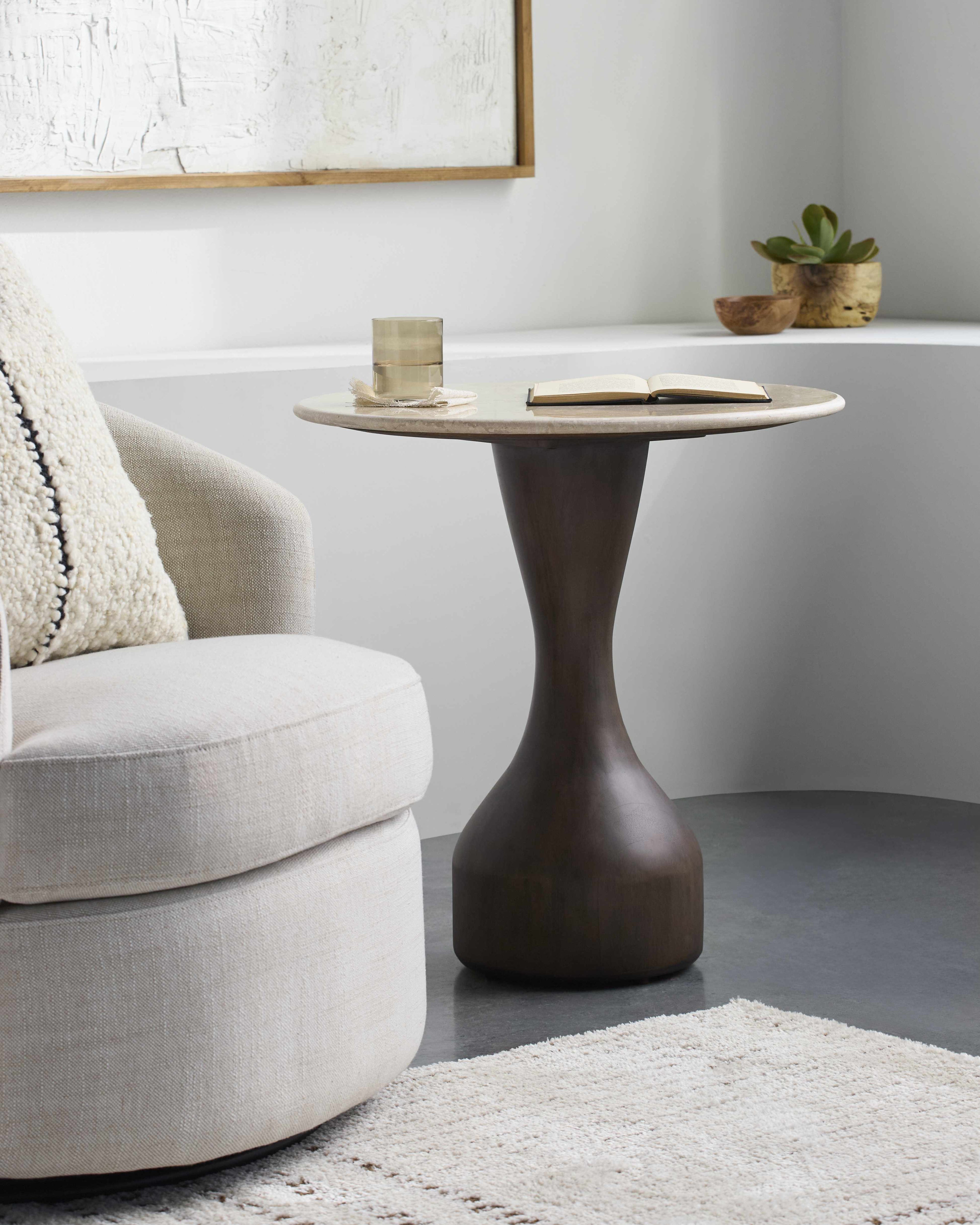 Contemporary minimalist side table with natural mango wood base and marble top modern end table in a living room